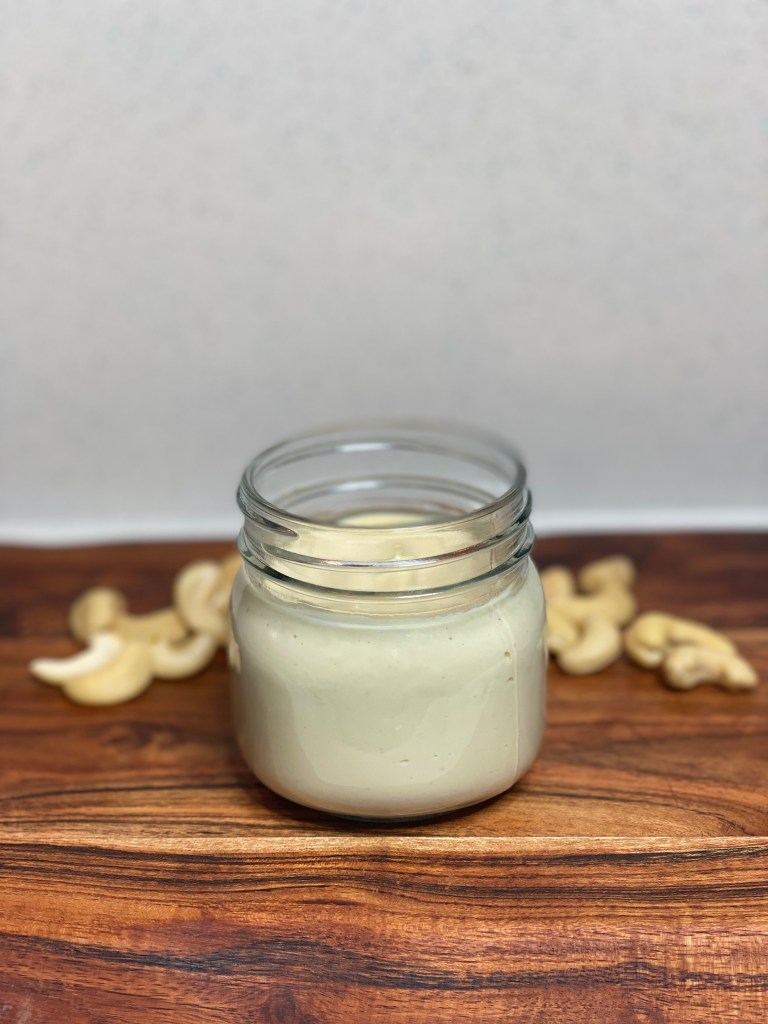 Homemade plant based mozzarella creamy sauce in a mason jar.