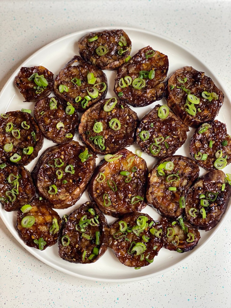 Delicious plate of baked eggplant with green onion.