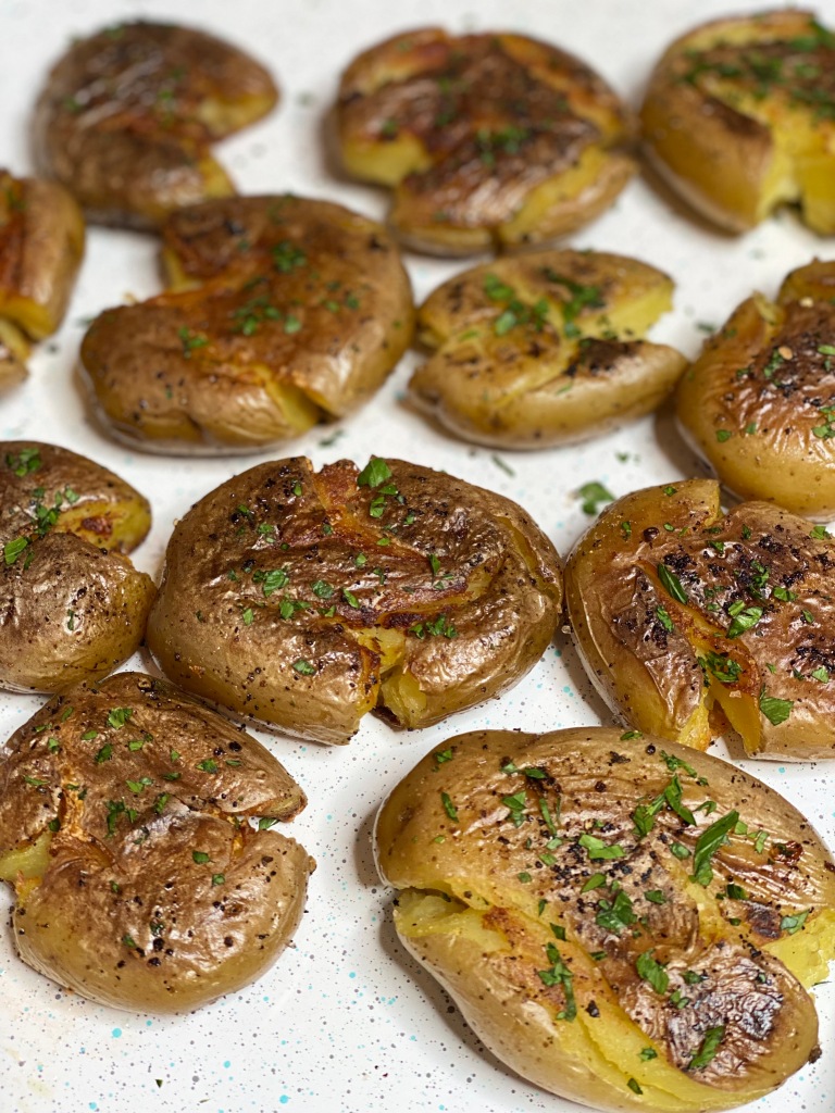 Crunchy pan-fried potatoes garnished with parsley.